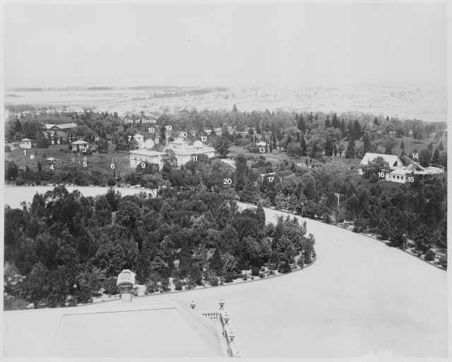 Aerial view of buildings among parkland
